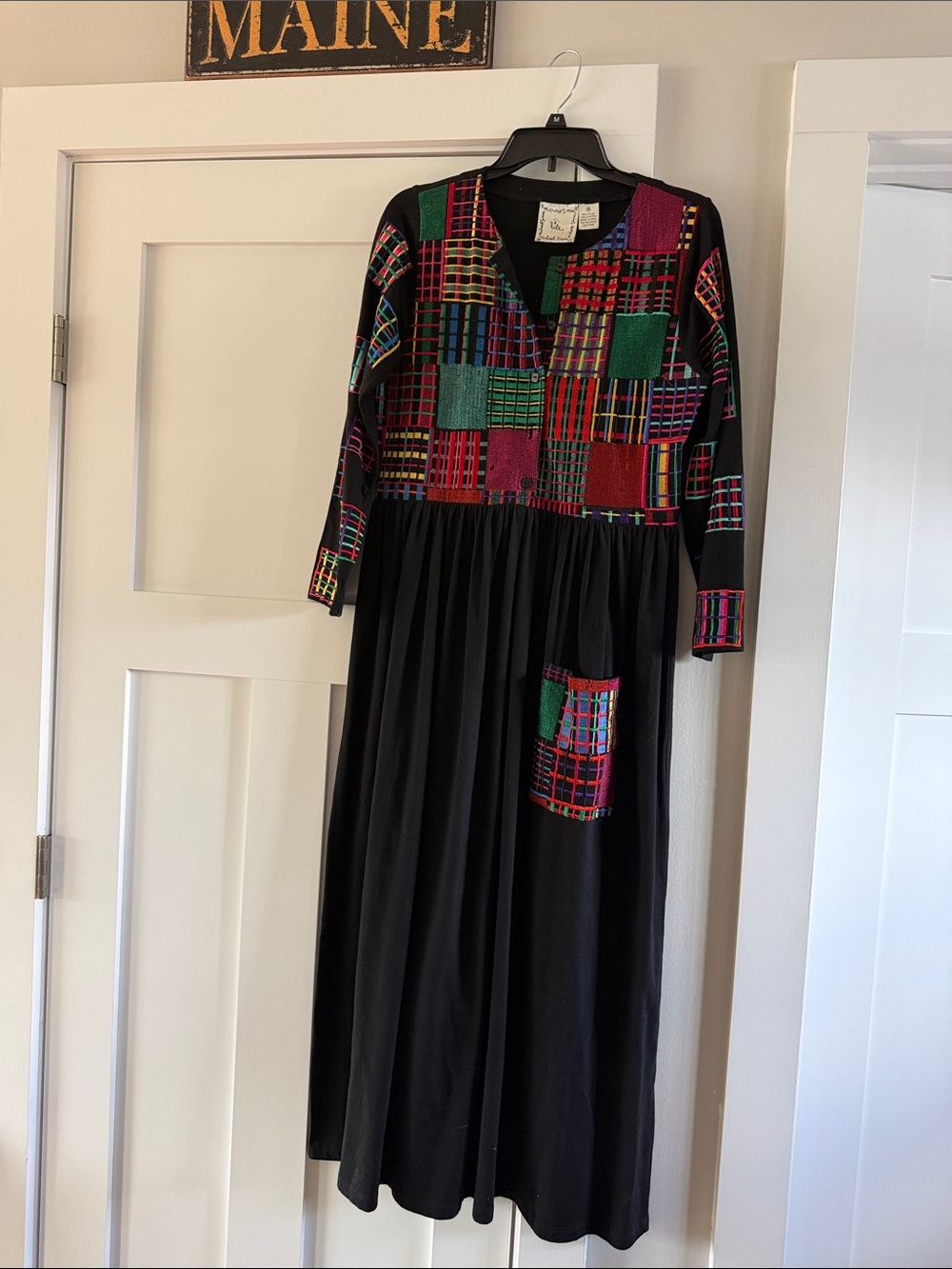 vintage Michael Simon long-sleeve black dress featuring colorful embroidery